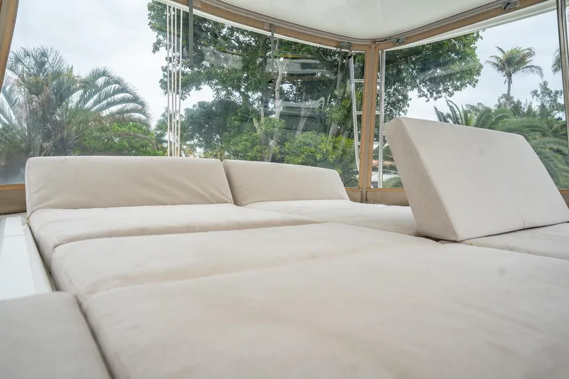 Slide: The Image of Luxurious interior of 2022 Lagoon 46 catamaran with plush seating and panoramic windows. - 146