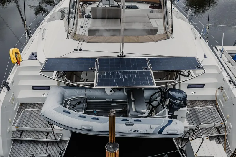Slide: The Image of 2022 Lagoon 46 catamaran with solar panels and inflatable dinghy on deck. - 148