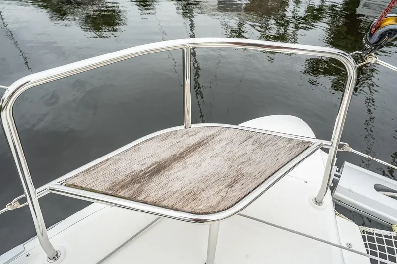 Slide: The Image of Deck detail of 2022 Lagoon 46 catamaran with stainless steel railing and wooden platform. - 150