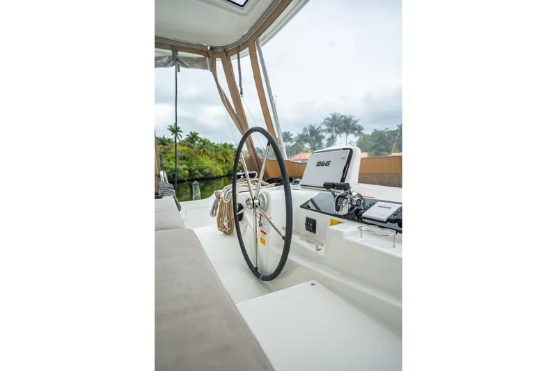 Slide: The Image of Cockpit of 2022 Lagoon 46 catamaran with steering wheel and navigation equipment. - 151