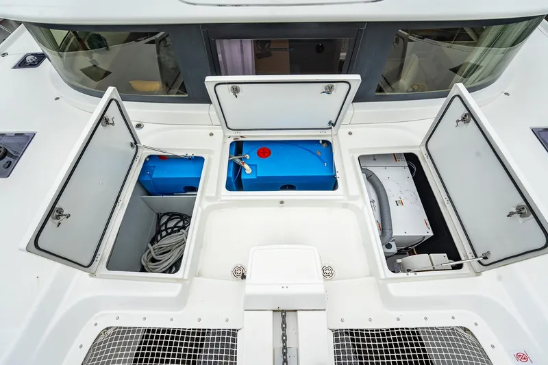 Slide: The Image of 2022 Lagoon 46 yacht deck with open storage compartments and equipment. - 152
