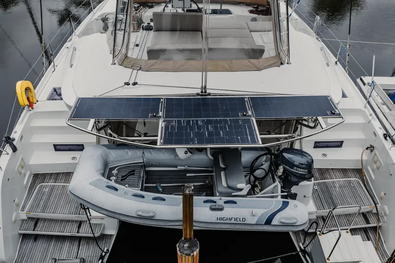 Slide: The Image of 2022 Lagoon 46 catamaran with solar panels and inflatable dinghy on deck. - 154