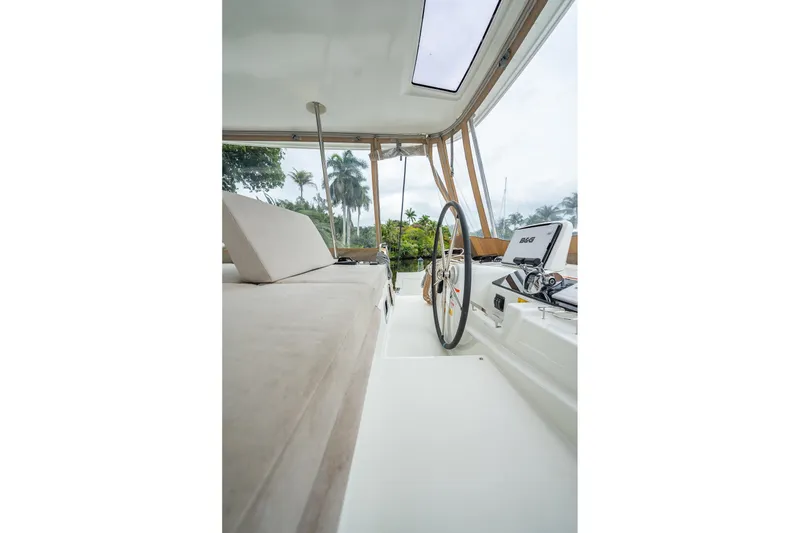 Slide: The Image of Interior view of 2022 Lagoon 46 catamaran with steering wheel and seating area. - 158