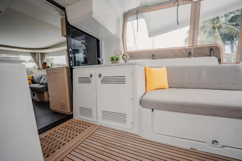 Slide: The Image of Interior of 2022 Lagoon 46 yacht with modern seating and wooden flooring. - 16