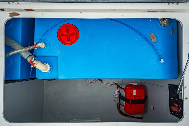 Slide: The Image of Blue water tank and red battery in 2022 Lagoon 46 yacht compartment. - 167