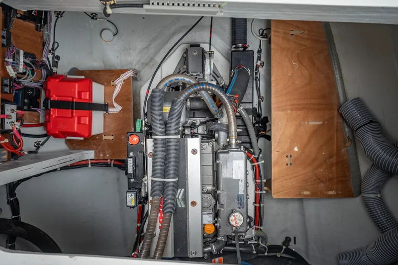 Slide: The Image of Engine compartment of a 2022 Lagoon 46 catamaran, showcasing mechanical components and wiring. - 169