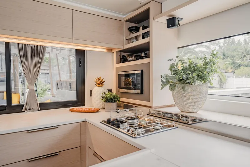 Slide: The Image of Modern kitchen interior of 2022 Lagoon 46 yacht with sleek design and large windows. - 17