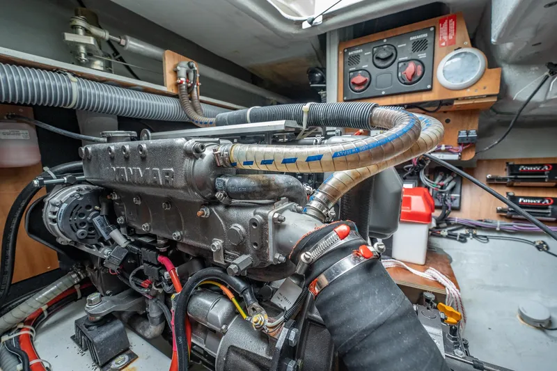 Slide: The Image of Engine room of 2022 Lagoon 46 yacht, featuring Yanmar engine and control panel. - 174