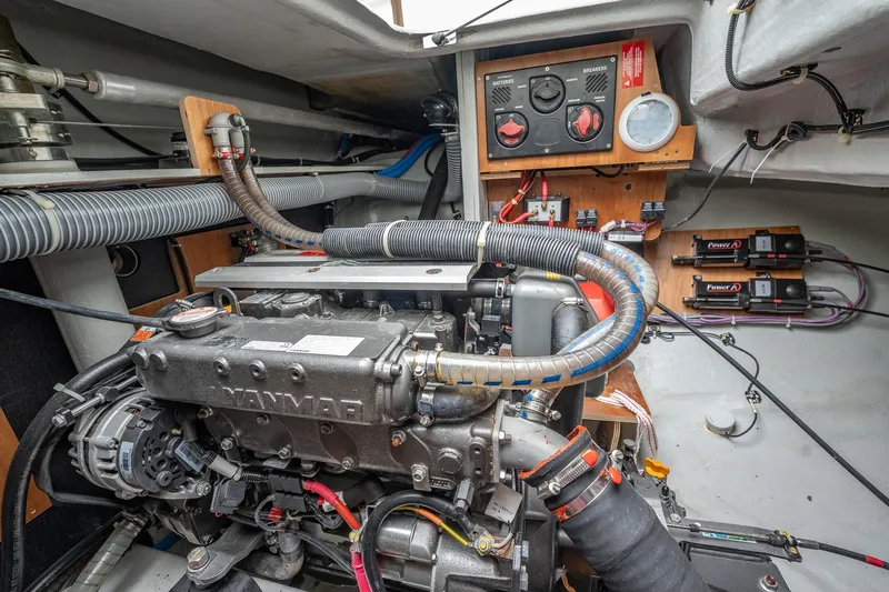 Slide: The Image of Engine room of a 2022 Lagoon 46 yacht, featuring a Yanmar engine and control panel. - 178