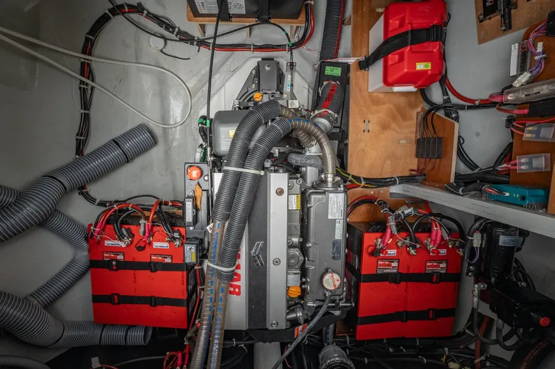 Slide: The Image of Engine room of a 2022 Lagoon 46 catamaran with batteries and wiring. - 182