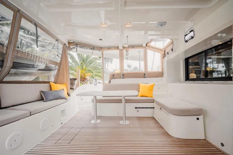Slide: The Image of Spacious interior of 2022 Lagoon 46 catamaran with modern seating and wooden flooring. - 2