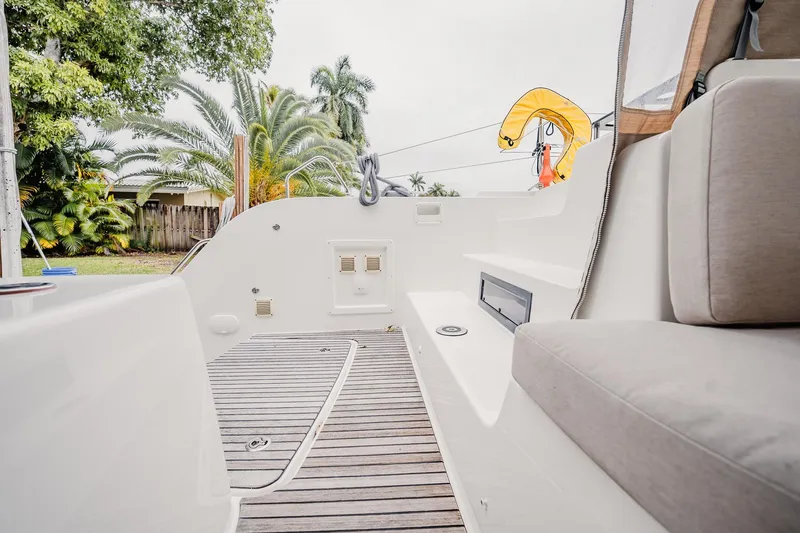 Slide: The Image of 2022 Lagoon 46 yacht deck with seating, showcasing modern design and lush surroundings. - 22