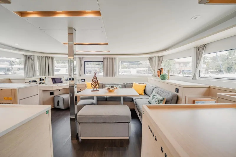 Slide: The Image of Luxurious interior of 2022 Lagoon 46 catamaran with modern furnishings and panoramic windows. - 28