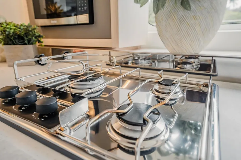 Slide: The Image of Modern kitchen stove in 2022 Lagoon 46 yacht, featuring sleek stainless steel design. - 29