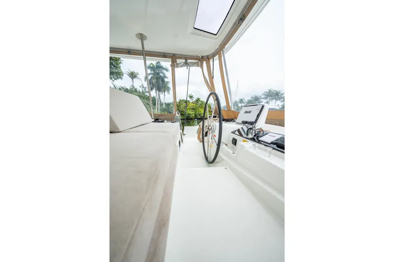 Slide: The Image of Interior view of 2022 Lagoon 46 catamaran helm with steering wheel and navigation equipment. - 5