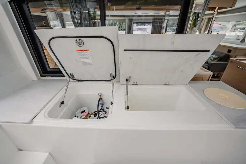 Slide: The Image of Open storage compartment on 2022 Lagoon 46 yacht, showcasing interior details and equipment. - 50