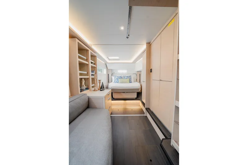 Slide: The Image of Luxurious interior of 2022 Lagoon 46 yacht featuring modern bedroom and cozy seating area. - 57
