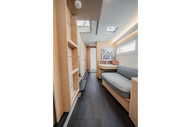 Slide: The Image of Interior of 2022 Lagoon 46 yacht, featuring modern design with light wood and cozy seating. - 60