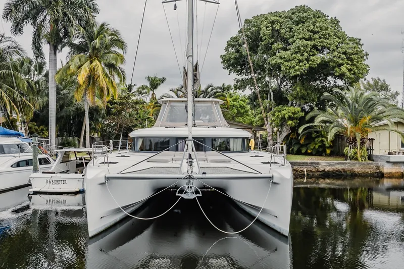 Slide: The Image of 2022 Lagoon 46 catamaran docked in a tropical marina setting. - 71