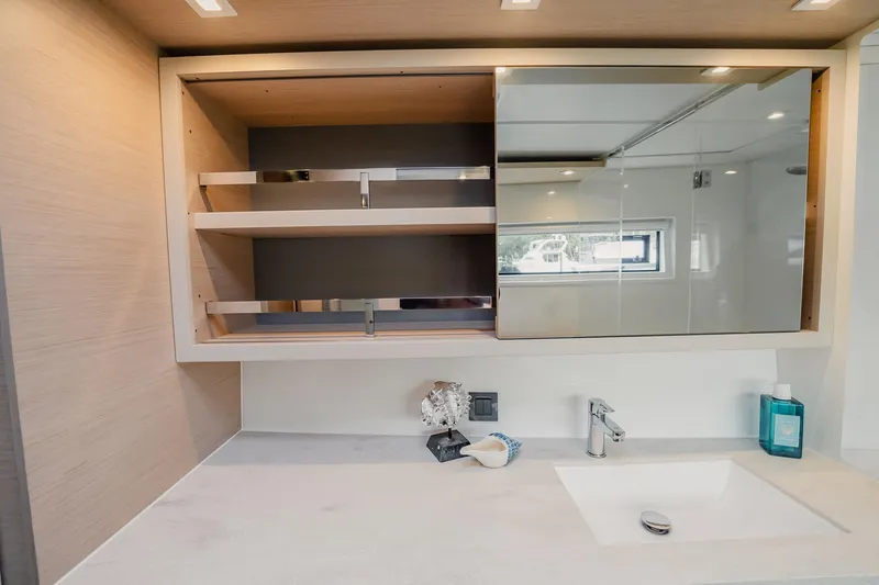 Slide: The Image of Modern bathroom vanity in 2022 Lagoon 46 yacht with open shelving and sleek design. - 77