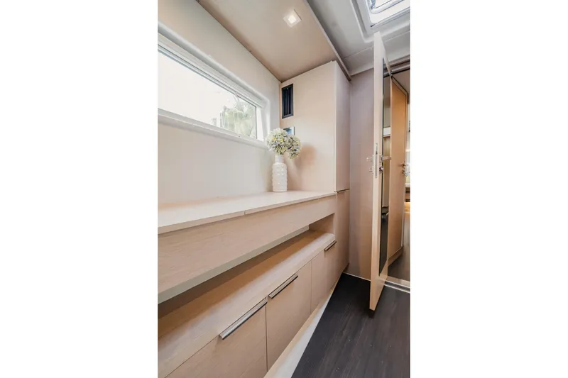 Slide: The Image of Interior of 2022 Lagoon 46 yacht with modern cabinetry and natural light. - 81