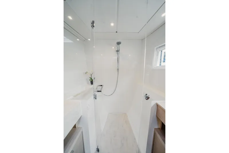 Slide: The Image of Modern shower area in 2022 Lagoon 46 yacht, featuring sleek design and bright lighting. - 83