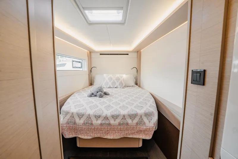 Slide: The Image of Luxurious bedroom interior of 2022 Lagoon 46 yacht with elegant bedding and soft lighting. - 96