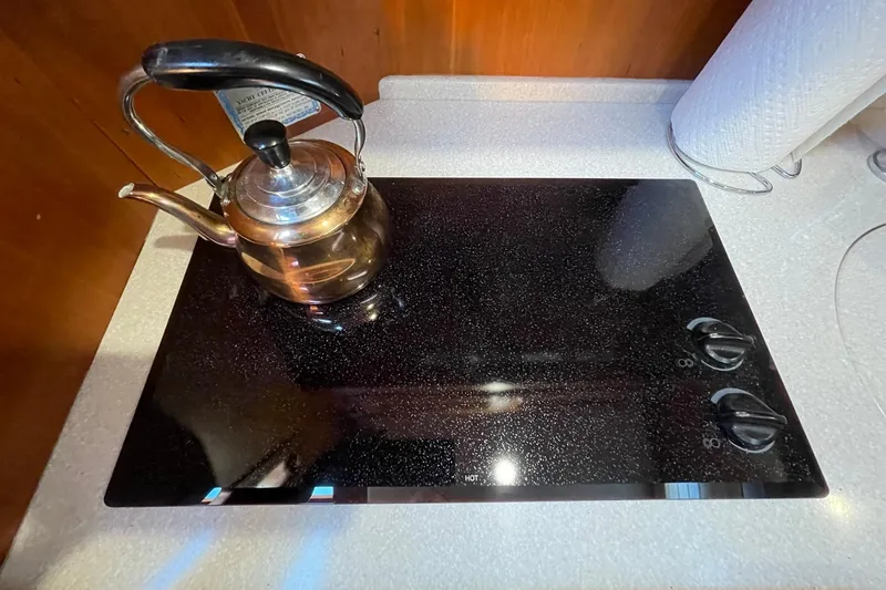 Slide: The Image of Stovetop with kettle on Sabre 38 Salon Express, 2008 model, featuring sleek design. - 12