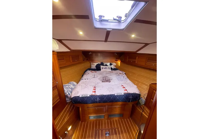 Slide: The Image of Cozy cabin interior of 2008 Sabre 38 Salon Express with nautical-themed bedding. - 14