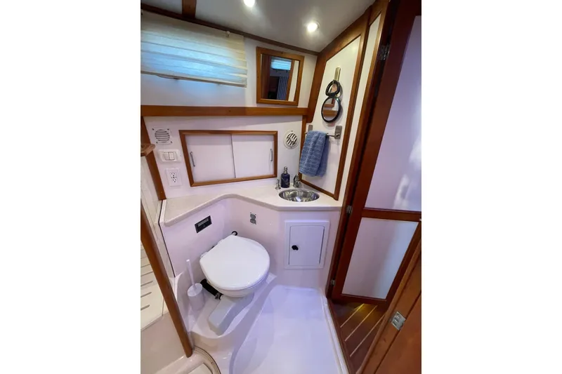 Slide: The Image of 2008 Sabre 38 Salon Express bathroom with toilet, sink, and wooden accents. - 19