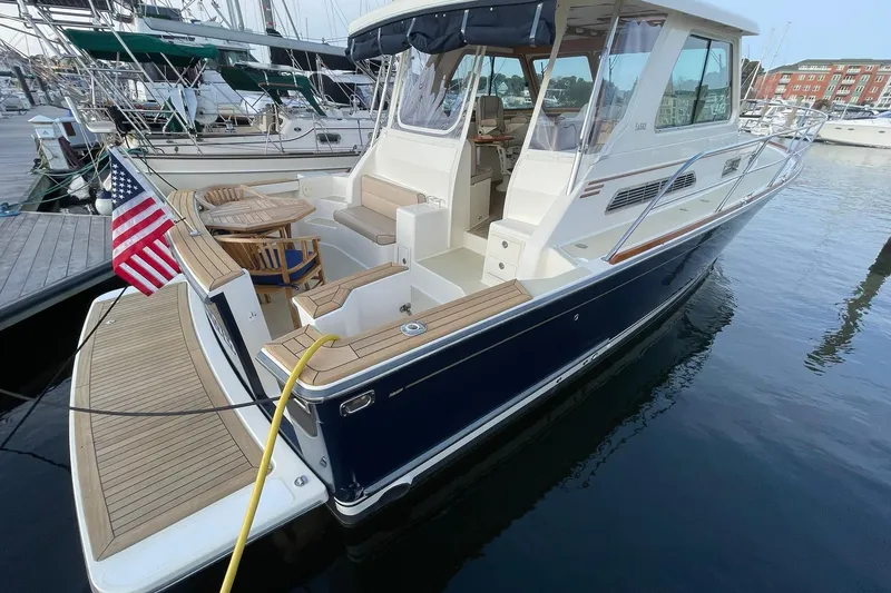 Slide: The Image of 2008 Sabre 38 Salon Express yacht docked, featuring elegant design and spacious deck area. - 2