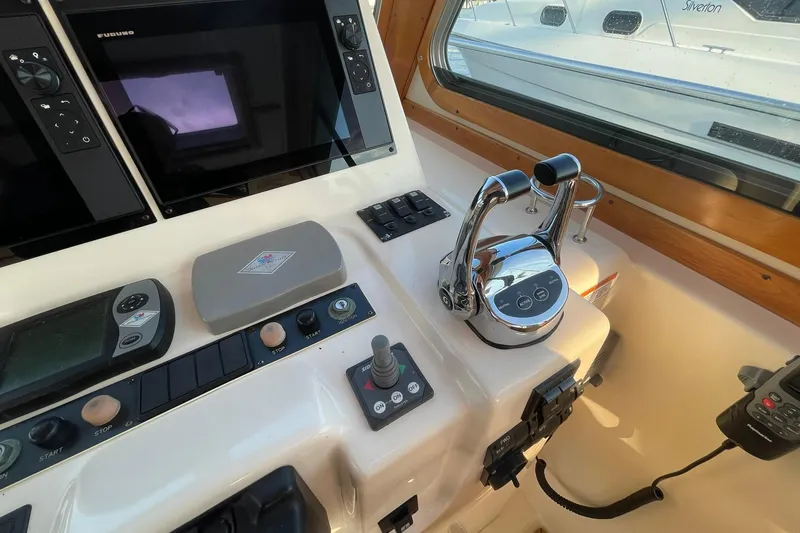 Slide: The Image of Control panel of 2008 Sabre 38 Salon Express yacht with navigation equipment and throttle levers. - 38