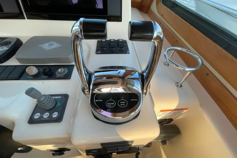 Slide: The Image of Control panel of 2008 Sabre 38 Salon Express yacht with throttle and joystick. - 39