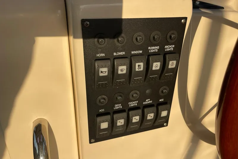 Slide: The Image of Control panel on a 2008 Sabre 38 Salon Express yacht, featuring various switches. - 40