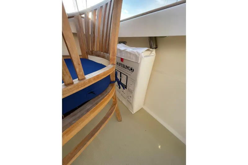 Slide: The Image of Wooden chair and life raft on 2008 Sabre 38 Salon Express yacht deck. - 47