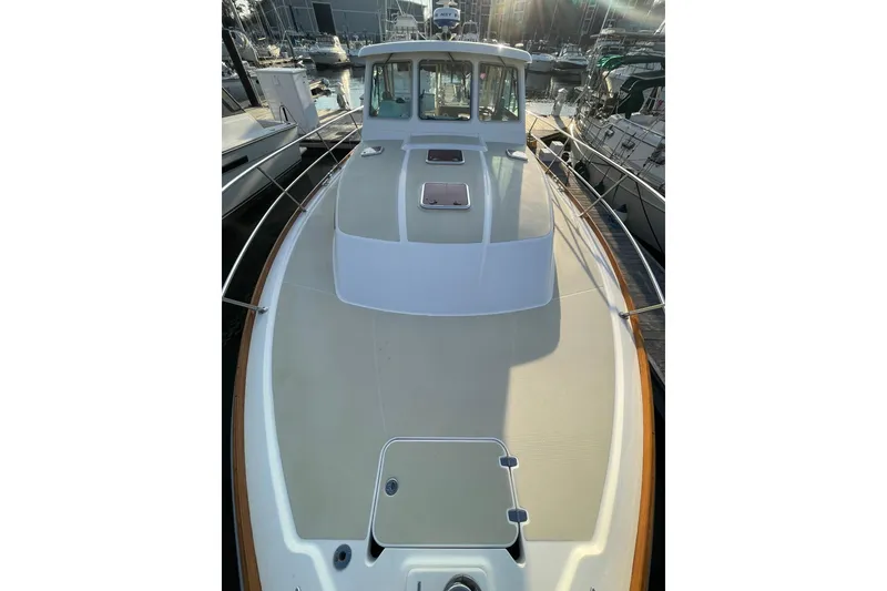 Slide: The Image of 2008 Sabre 38 Salon Express yacht docked at marina, showcasing spacious deck and sleek design. - 58