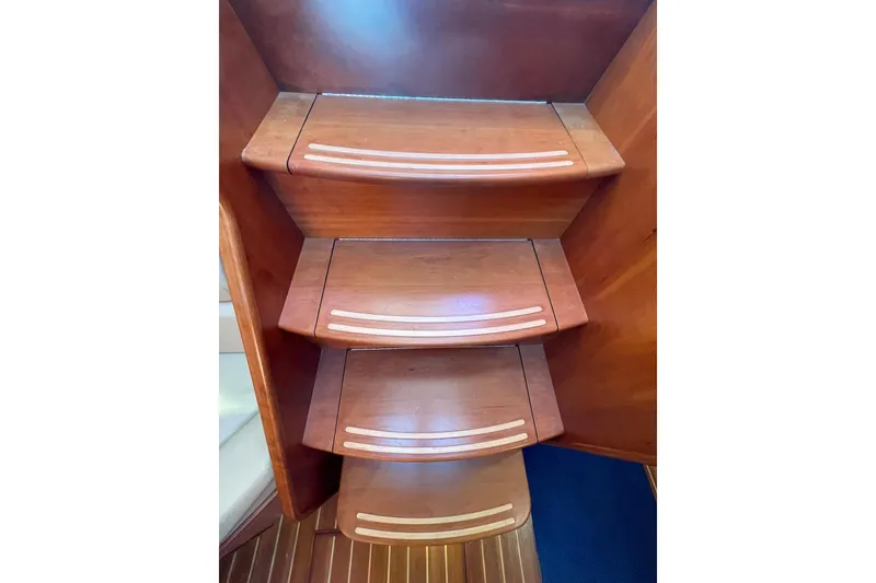 Slide: The Image of Wooden steps inside a 2008 Sabre 38 Salon Express yacht, featuring sleek design and craftsmanship. - 6