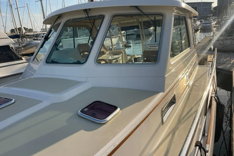 Slide: The Image of 2008 Sabre 38 Salon Express yacht docked at marina, showcasing sleek design and windows. - 63