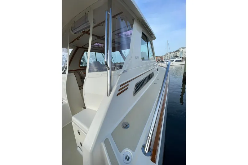 Slide: The Image of 2008 Sabre 38 Salon Express yacht docked, showcasing sleek design and polished railings. - 65
