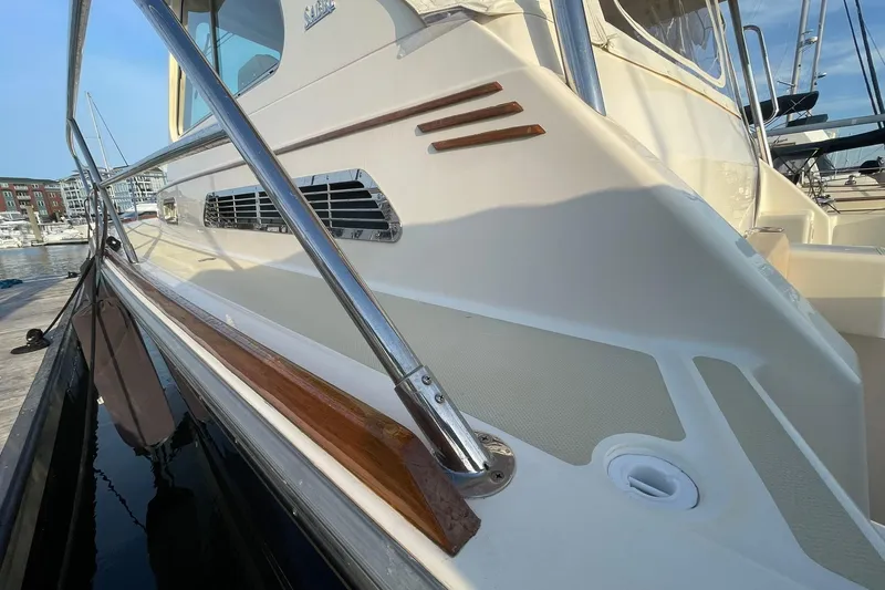Slide: The Image of 2008 Sabre 38 Salon Express yacht docked at marina, showcasing sleek design and polished wood accents. - 67