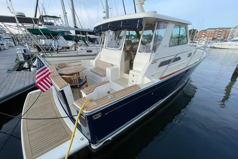 Slide: The Image of 2008 Sabre 38 Salon Express yacht docked at marina, featuring elegant design and American flag. - 78
