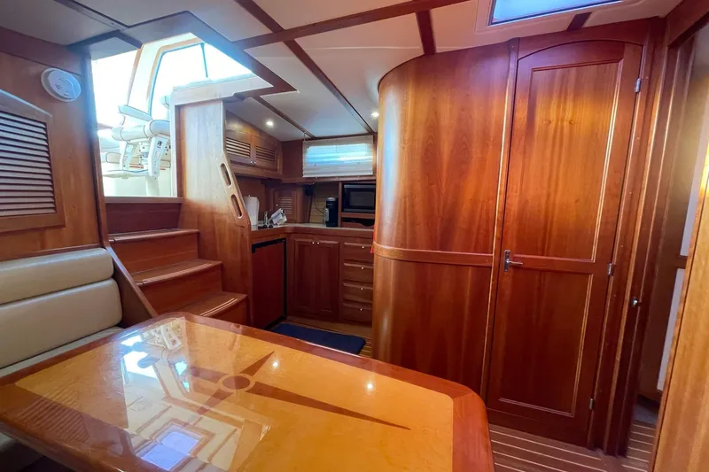 Slide: The Image of 2008 Sabre 38 Salon Express interior with wooden cabinetry, stairs, and dining area. - 8