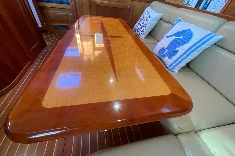 Slide: The Image of Luxurious interior of 2008 Sabre 38 Salon Express with elegant wooden table and nautical-themed cushions. - 9