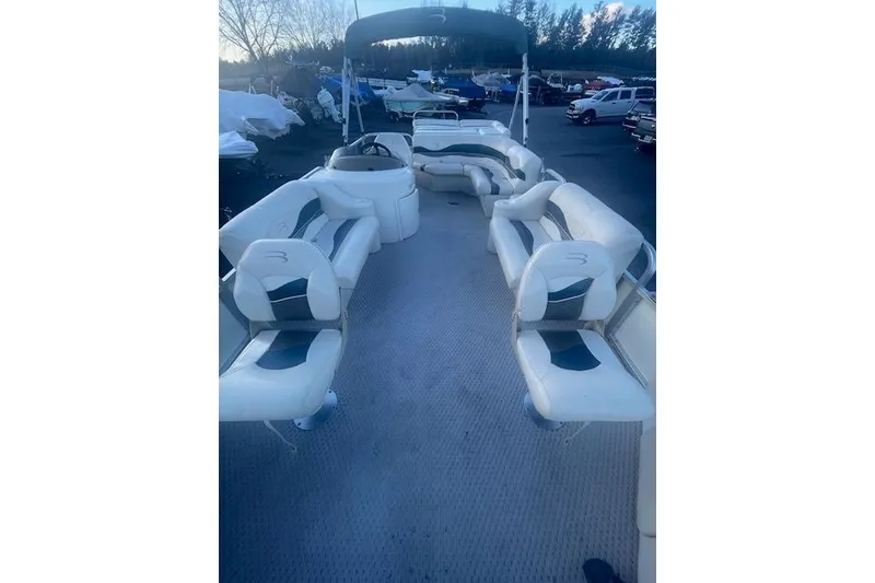 Slide: The Image of 2006 Bennington 2075 GS pontoon boat with spacious seating and canopy in a marina setting. - 6
