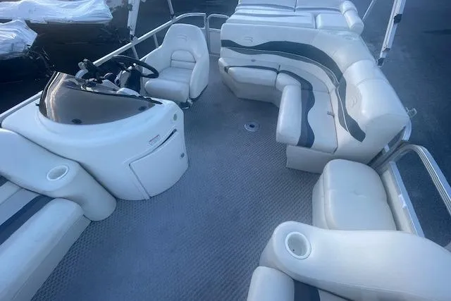 Slide: The Image of 2006 Bennington 2075 GS pontoon boat interior with white seating and steering console. - 7