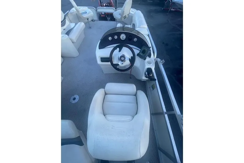 Slide: The Image of 2006 Bennington 2075 GS boat interior with steering wheel and seating. - 8