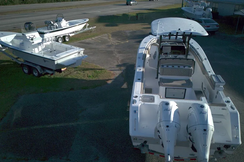 Slide: The Image of 2026 Sea Hunt Gamefish 27 Forward Seating boat with dual engines, parked on a trailer. - 3