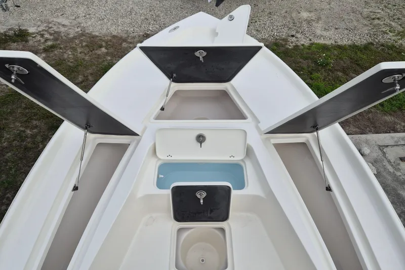 Slide: The Image of 2026 Key West 250 Bay Reef boat storage compartments and livewell, open view. - 11