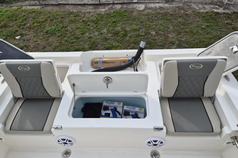 Slide: The Image of 2026 Key West 250 Bay Reef boat interior with storage and seating. - 13