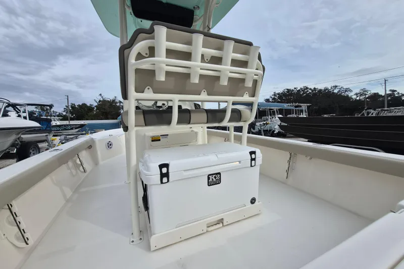 Slide: The Image of 2026 Key West 250 Bay Reef boat interior with seating and cooler. - 4